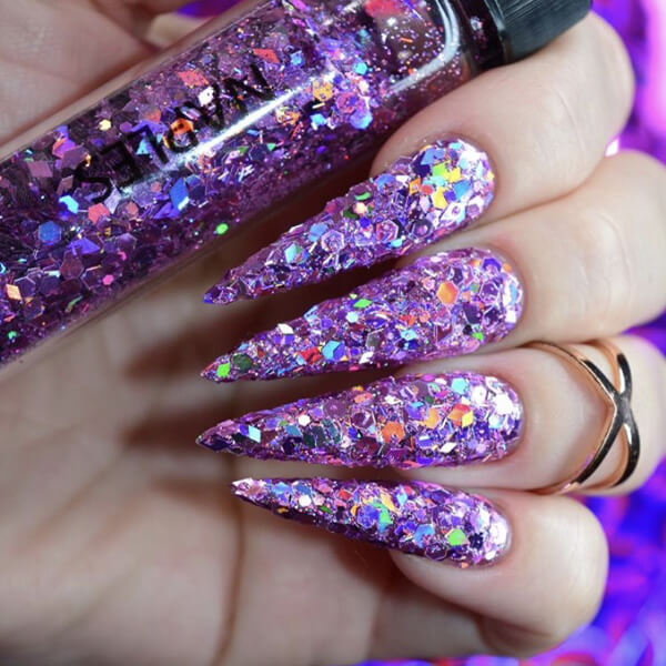 Close-up of colorful nail glitters in various shades and textures, perfect for adding sparkle and shine to nail art designs.